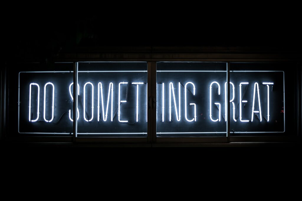 Neon sign that reads "do something great"